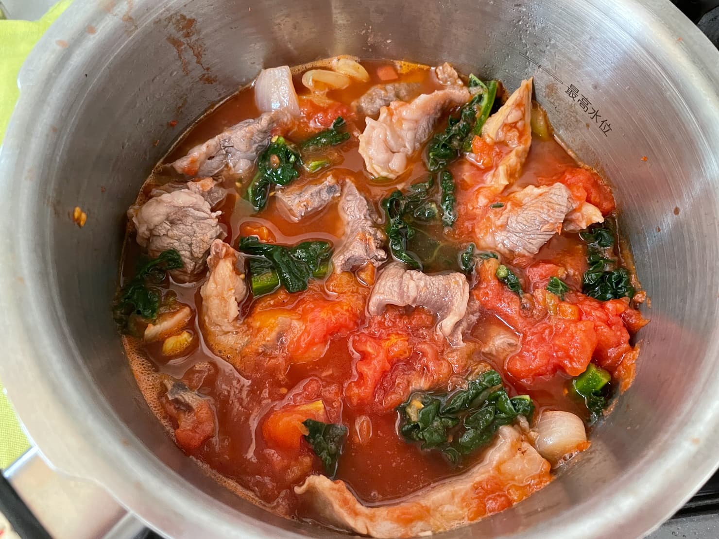 牛スネ肉とカーボロネロのトマト煮込みを煮ているところの写真